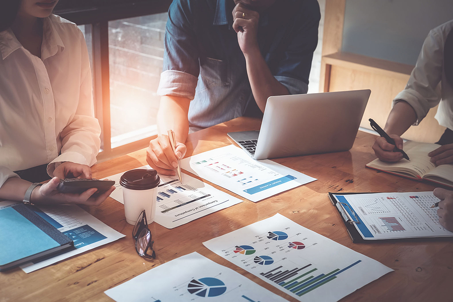 Business professionals discussing what makes their company unique in the marketplace, showcasing distinct qualities and advantages.